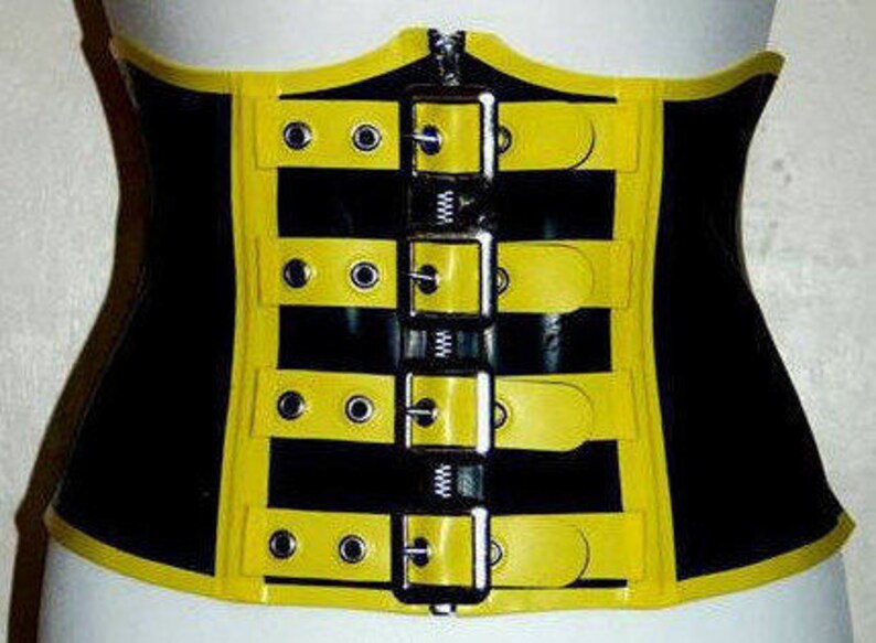 May include: A black and yellow latex corset with multiple adjustable buckles. The corset has a zipper closure in the front.