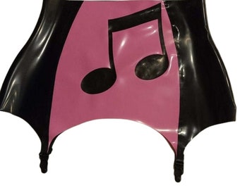May include: Black and pink latex garter belt featuring a musical note design. The garter belt has a wide waistband and adjustable straps. The pink section is in the center, with black on either side.