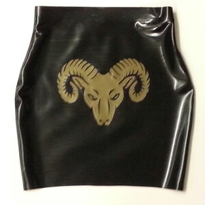 A black latex mini skirt with a gold ram head design