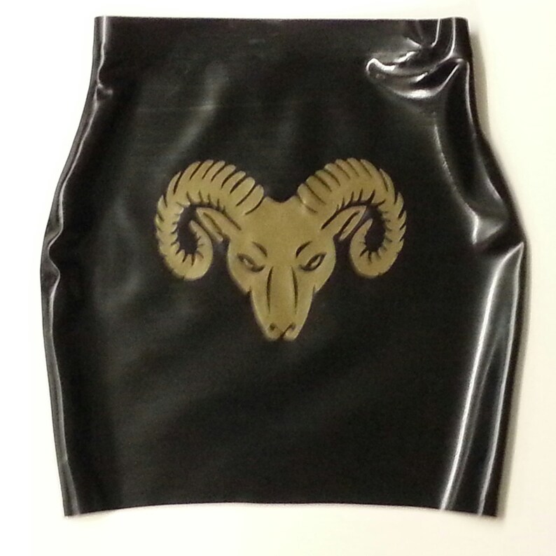 A black latex mini skirt with a gold ram head design