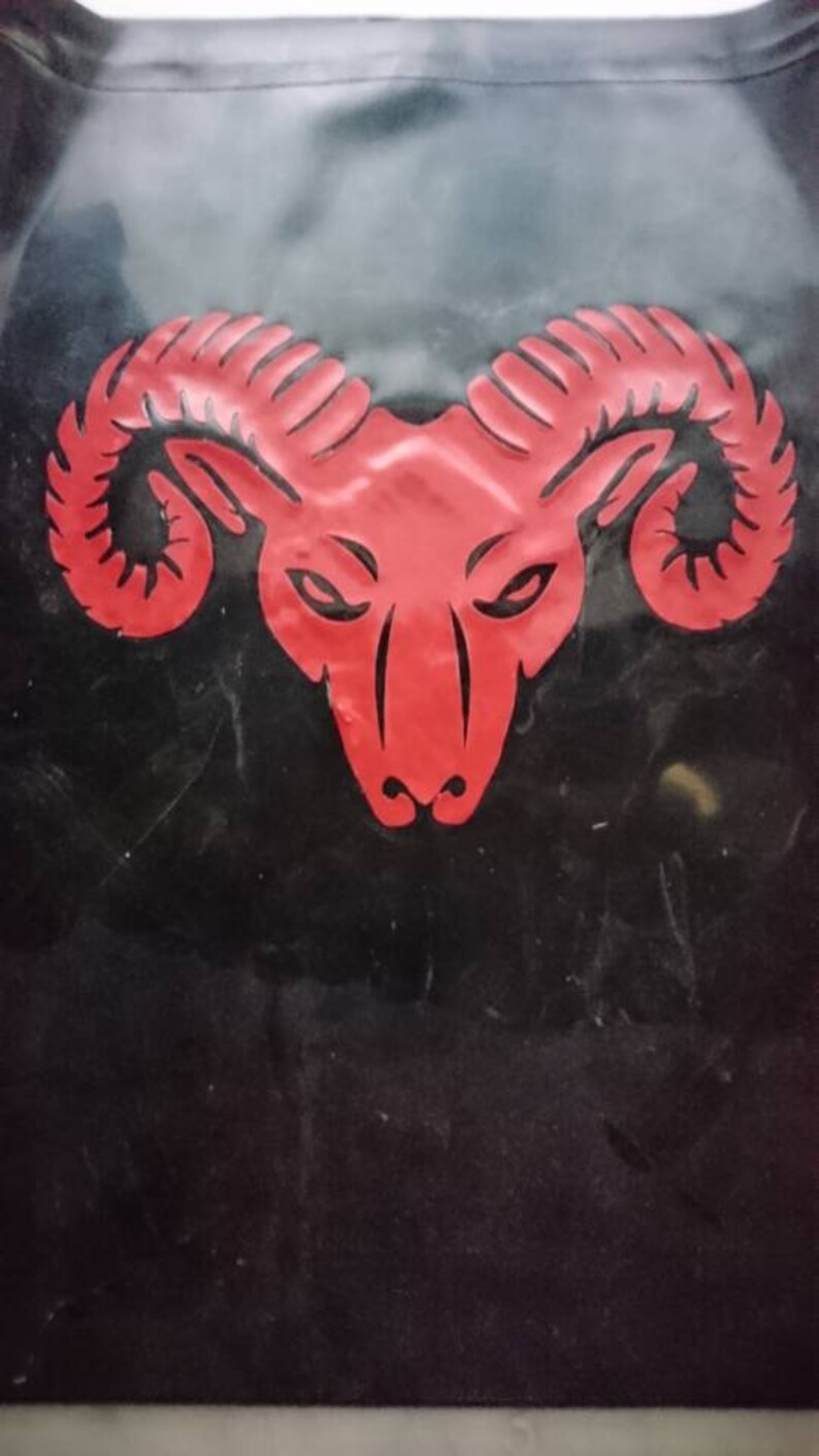A red ram head with horns on a black background.
