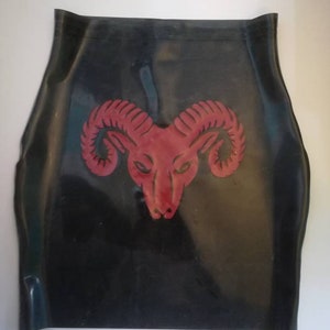 A black rubber skirt with a red ram head design in the center.