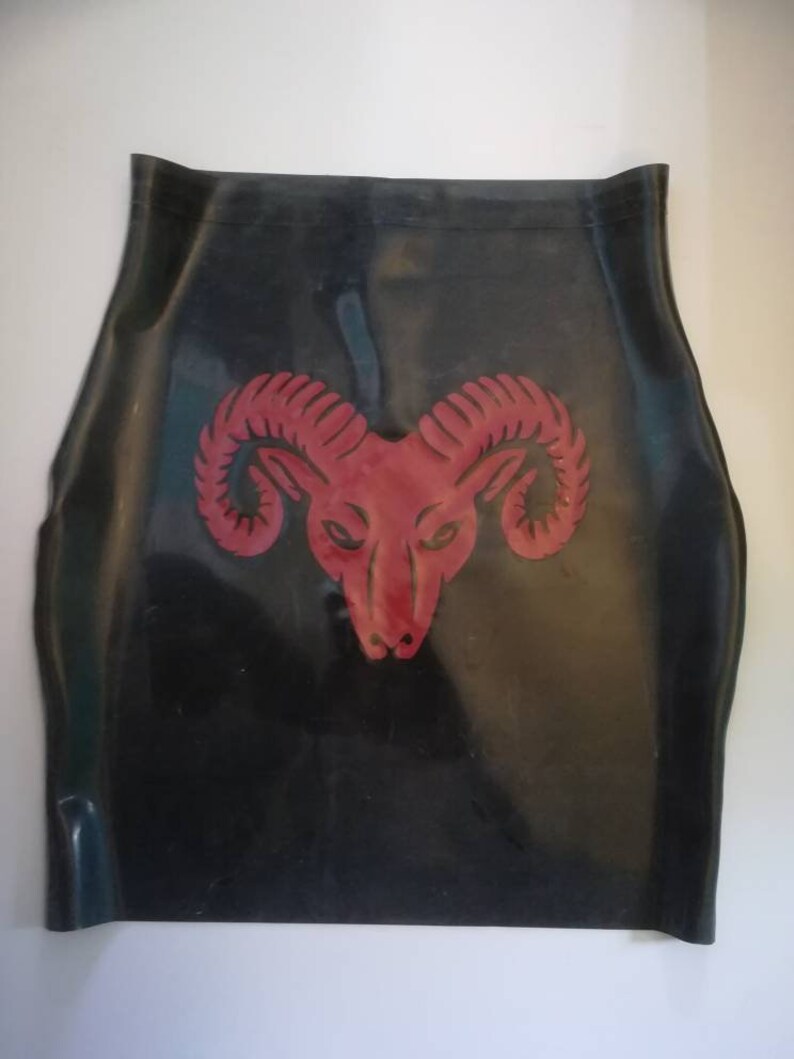 A black rubber skirt with a red ram head design in the center.