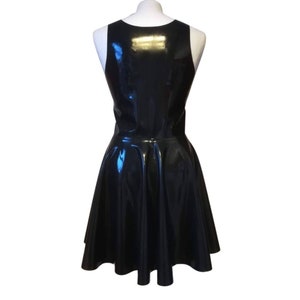 A black sleeveless latex dress with a flared skirt.
