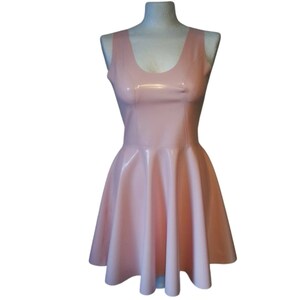 A sleeveless, pink latex dress with a scoop neck and a flared skirt.