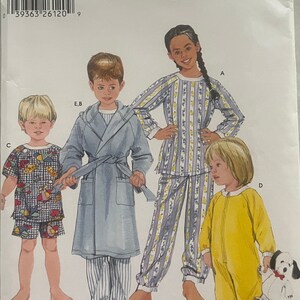 May include: Simplicity sewing pattern number 5874 for children's pajamas. The pattern includes four different styles: a striped pajama set, a robe, a pajama top and bottom set, and a one-piece sleeper. The pattern is for sizes AA, 1/2, 1, and 2.