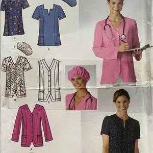May include: A sewing pattern for a medical scrub top, jacket, and pants. The pattern includes a variety of styles, including a V-neck top, a button-up jacket, and a pair of pants with pockets. The pattern is designed for sizes BB 20W-28W. The pattern is from Simplicity and is easy to sew.