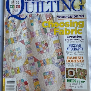 May include: The cover of "American Patchwork & Quilting" magazine, June 2015 issue, features a colourful quilt with square patterns. Text includes "Choosing Fabric" and "Banish Boring!" The magazine is a "Big Color Issue."