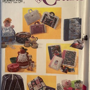 May include: A Simplicity Crafts sewing pattern for making various home decor items, including a tissue box cover, a photo album, a teapot cozy, and a storage box. The pattern includes instructions for making each item, as well as a list of materials needed.