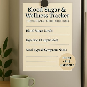 May include: A beige magnetic tracker titled "Blood Sugar & Wellness Tracker" with lines for tracking blood sugar levels, injections, and meal notes. A green mug sits on a wooden surface. The tracker includes the text "PRINT • PIN • USE DAILY."