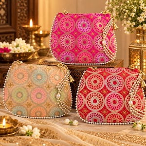 May include: Three semi-circular handbags featuring intricate circular embroidery patterns in bright pink, red, and pastel tones. Each bag is adorned with a delicate white pearl beaded trim along the edges and a dangling pearl tassel accent.