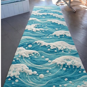 May include: A rectangular runner rug featuring a repeating pattern of stylized ocean waves. The design consists of deep blue and light turquoise water currents with raised, textured white foam crests and scattered bubbles.