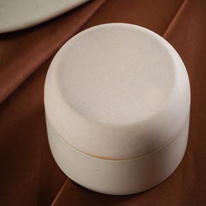 Bottom view of minimalist handmade ceramic cup showing unglazed stoneware base