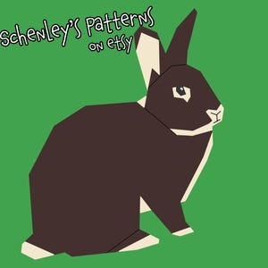 Könnte beinhalten: Ein braunes und weißes Kaninchen mit einem weißen Fleck auf der Nase, das auf einem grünen Hintergrund sitzt. Der Text "Schenley's Patterns on Etsy" befindet sich in der oberen linken Ecke des Bildes.