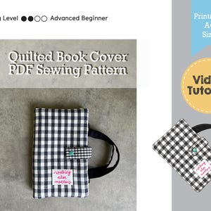 May include: A black and white gingham quilted book cover with a black handle and a matching clasp. The cover has the text "nothing else matters" on a small patch. The image also includes text that says "Quilted Book Cover PDF Sewing Pattern".