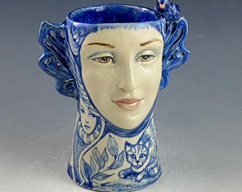 Blue and white face vase with blue bird and carved wings 7.25 inches tall OOAK hand modeled sweet face with cat and more hand painted