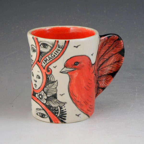 Red bird cup, porcelain with faces and the word Imagine, OOAK