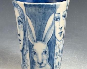 Blue and white ceramic story cup with birds,rabbit, cat and more