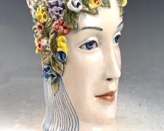 5.25 inch tall face vase with multiple color applied flowers, one of a kind handmade