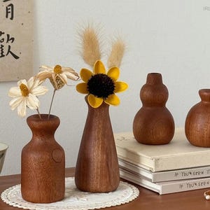 May include: A set of three ceramic mugs with a speckled, matte finish. The mugs are in shades of cream, light gray, and dark gray. Each mug has a simple, minimalist design, perfect for coffee or tea.