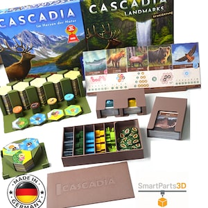 Peut inclure: Jeu de société Cascadia avec extension. L'illustration de la boîte présente un paysage de montagne avec un cerf. Les composants du jeu comprennent des cartes, des tuiles hexagonales et des jetons en bois. Fabriqué en Allemagne.