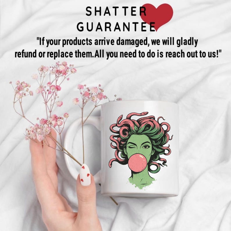 May include: White ceramic mug featuring a green-skinned woman with pink hair and a bubblegum bubble. The mug has the text "SHATTER GUARANTEE" and a guarantee statement. The mug is held near pink flowers.