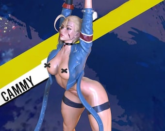 May include: A figurine of a female character in a dynamic pose, wearing a blue jacket with red and white accents, black gloves, and red boots. The figure has blonde hair and a black choker. The word "CAMMY" is visible on the left side of the image.