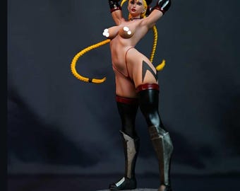 May include: A detailed figurine of a female character in a dynamic pose. The figure has blonde hair in a long braid, wearing a red and black outfit with black boots. The figure is standing on a round, textured base.