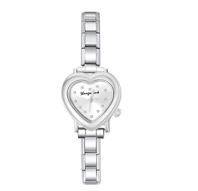 May include: A silver-toned wristwatch with a heart-shaped face. The watch face is white with small, round markers and the text "Shangfa ink". The watch band is made of linked metal segments.