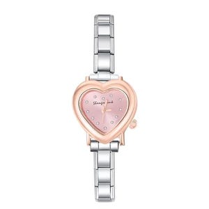 May include: A silver and rose gold wristwatch with a heart-shaped face. The watch face is pink with small, clear crystals and the words "Shanzin ink". The watch has a silver band.