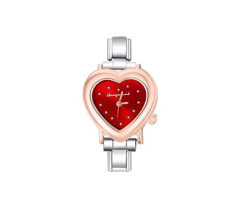 May include: A heart-shaped wristwatch with a red face and silver band. The watch face has small, sparkling accents and the text "Shining Time". The watch has a rose gold bezel and a silver band.