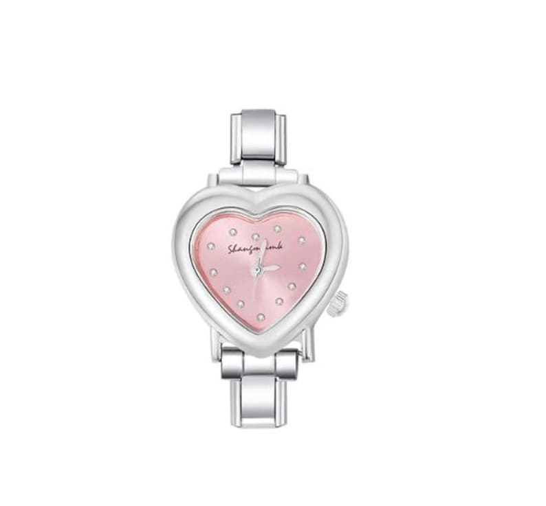 May include: A silver-toned wristwatch with a heart-shaped face. The watch face is pink with small dot hour markers and the text "Shanfan look". The watch band is also silver-toned.