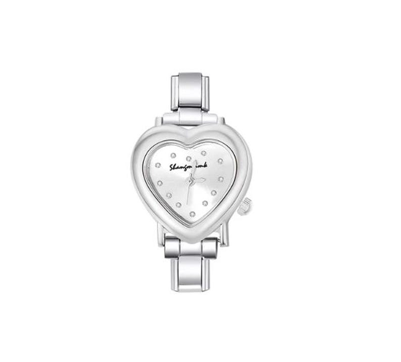 May include: A silver-toned wristwatch with a heart-shaped face. The watch face is white with small, round embellishments and the text "Shangfor ink". The watch has a metal band and a small dial on the side.