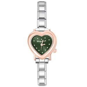 May include: A heart-shaped wristwatch with a green face and a rose gold-colored bezel. The watch has a silver-colored band and the text "Shemforbomb" is printed on the watch face. The watch hands are gold-colored.