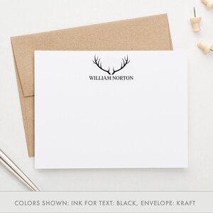May include: A white stationery card with a black antler design and the name "William Norton" printed in black text. The card is on a brown kraft envelope.