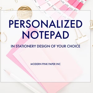 May include: A white background with a stack of pink paper, a pencil, gold paper clips, and silver binder clips. The text "PERSONALIZED NOTEPAD IN STATIONERY DESIGN OF YOUR CHOICE MODERN PINK PAPER INC" is written in a navy blue font.
