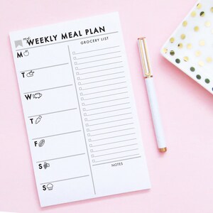 May include: A white printable weekly meal planner with a grocery list section and a notes section. The planner has a black border and includes icons for each day of the week.