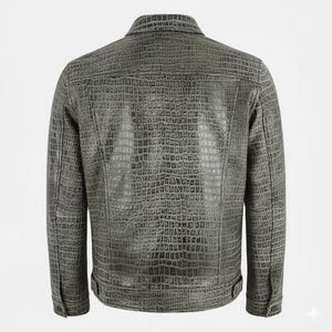 May include: A gray, textured jacket with a crocodile skin pattern. The jacket has a button-down front, a collar, and buttoned cuffs. The back of the jacket is visible, showcasing the detailed texture and design.