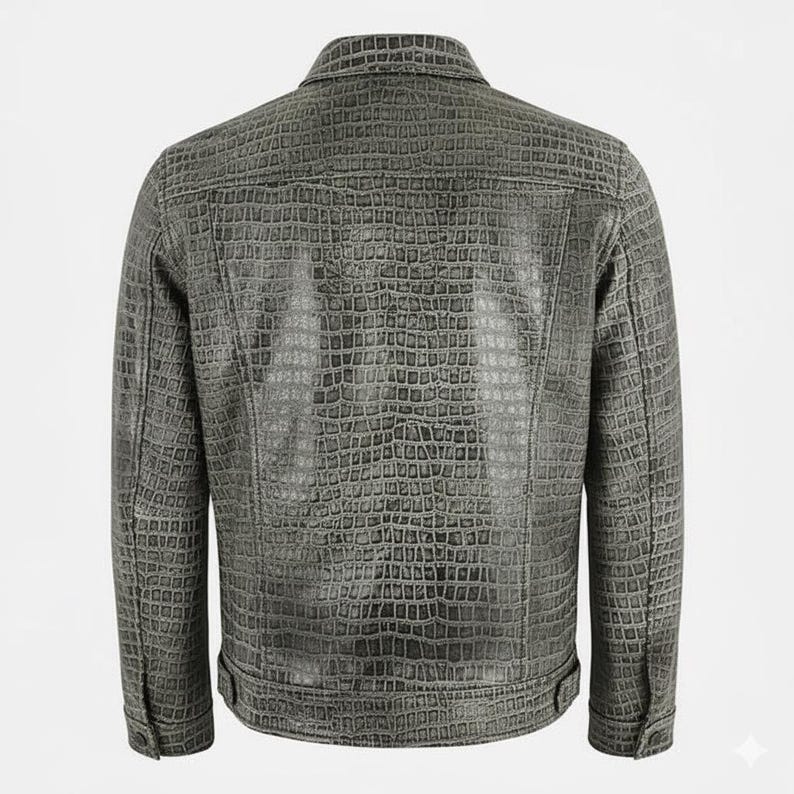 May include: A gray, textured jacket with a crocodile skin pattern. The jacket has a button-down front, a collar, and buttoned cuffs. The back of the jacket is visible, showcasing the detailed texture and design.