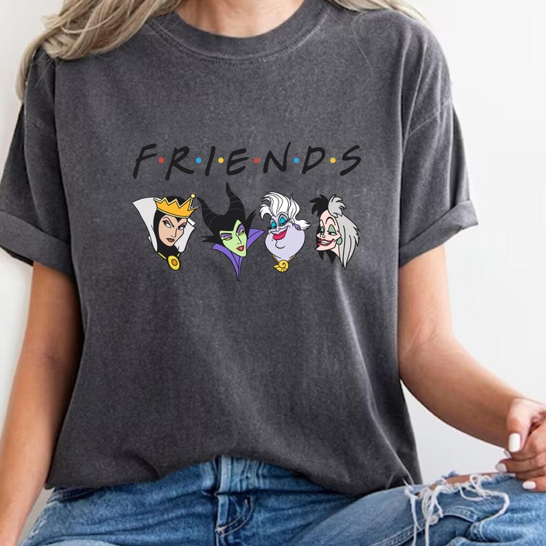May include: Dark gray t-shirt featuring the word "FRIENDS" in the style of the TV show logo, with cartoon images of Disney villains below. The villains include the Evil Queen, Maleficent, Ursula, and Cruella.