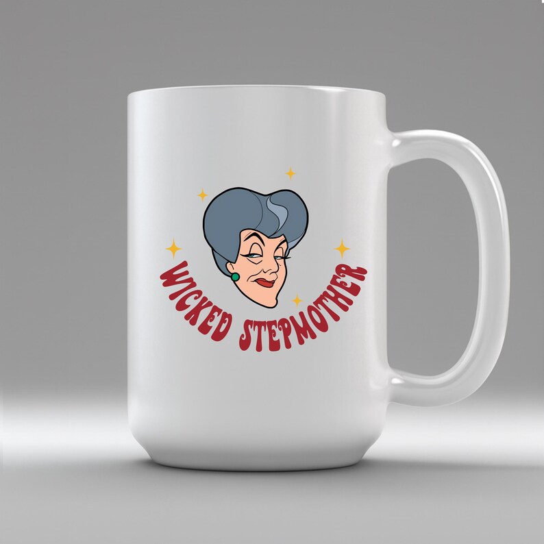 May include: White ceramic mug featuring a cartoon illustration of a woman with gray hair and the text "WICKED STEPMOTHER" in red. The design includes yellow star accents. The mug has a large handle.