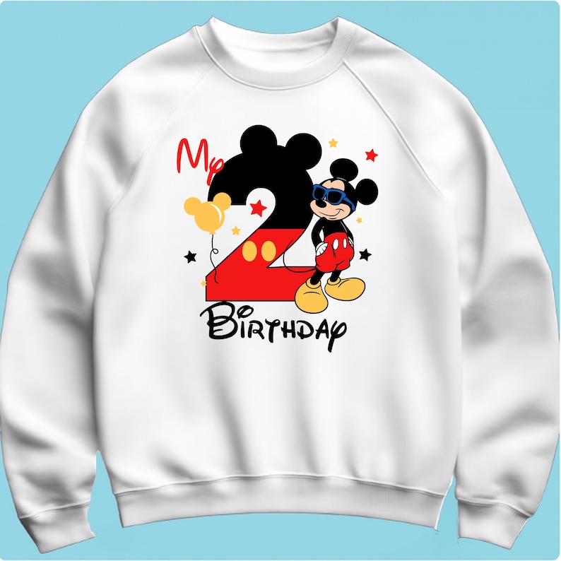 May include: White sweatshirt featuring a graphic of Mickey Mouse wearing sunglasses, with the number 2 in red and yellow, and the words "My Birthday". Includes yellow balloons and black stars.