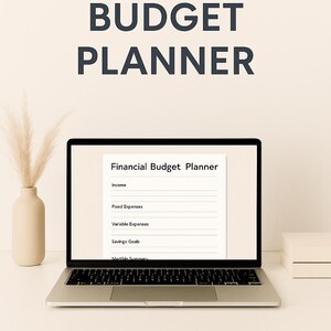 May include: A laptop showing a "Financial Budget Planner" document. The words "MONTHLY BUDGET PLANNER" and "DIGITAL LOFT DESIGNS" are printed above and below the laptop. A beige vase with dried plants is to the left.