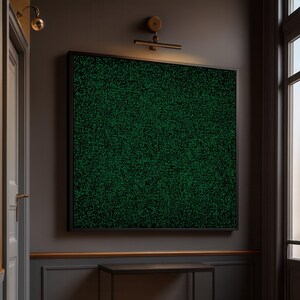 May include: A large square abstract art piece with a black frame. The artwork features a dense pattern of green shapes against a black background, creating a textured appearance. The piece is mounted on a dark gray wall, illuminated by a brass light fixture.