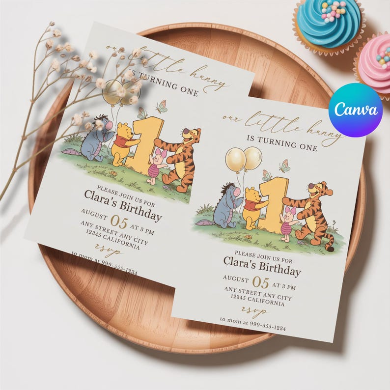 Op de afbeelding: Twee uitnodigingen voor Clara's eerste verjaardag, met Winnie de Poeh-personages. De uitnodigingen liggen op een houten dienblad, met cupcakes op de achtergrond. De tekst luidt "Clara's Birthday" en "August 05 at 3 PM".
