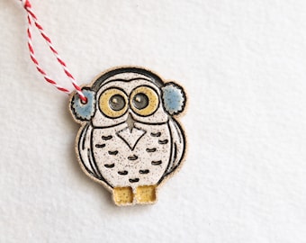 Snowy owl Christmas ornament wearing ear muffs
