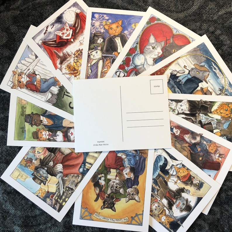 May include: A set of ten postcards featuring colorful illustrations of cats in various scenes. The postcards are blank on the back and have a space for a stamp. The text on the postcards includes "Hamlet" and "Erik Roe Morris".