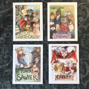 May include: Four illustrated cards featuring cats in various literary-themed scenes. The first card depicts a cat dressed as Edmond Dantes from "The Count of Monte Cristo" with the title "The Cat of Monte Cristo". The second card shows a group of cats dressed in 19th-century attire with the title "Purride and Prejudice". The third card features a cat dressed as Tom Sawyer with the title "Tomcat Sawyer". The fourth card shows a cat dressed as Dracula with the title "Catula, Lord of the Vampires".
