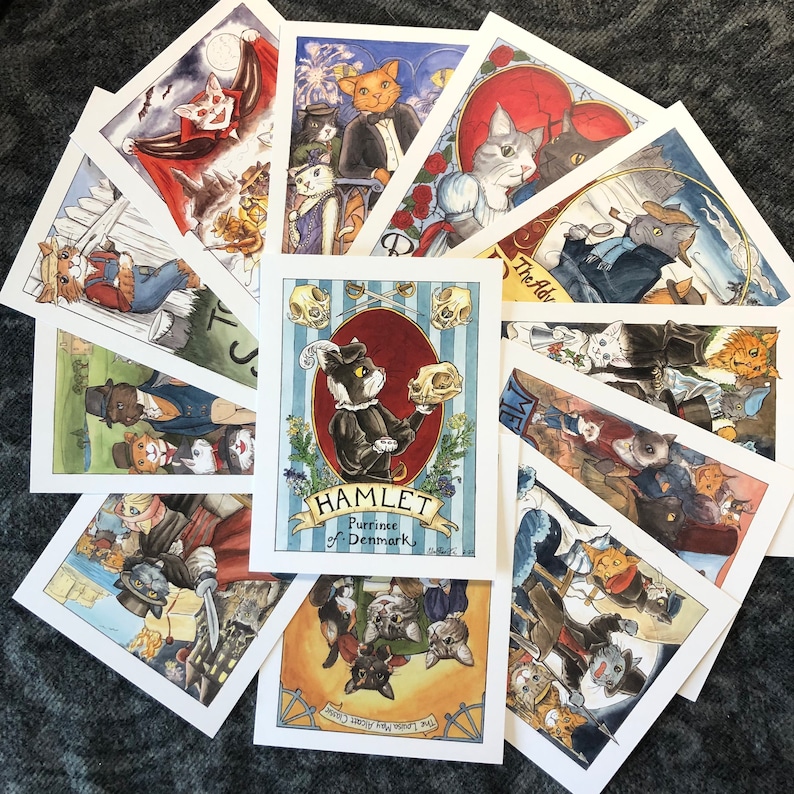 May include: A set of 10 illustrated cards featuring cats in various scenes. The cards are white with black borders and feature colorful illustrations. The cards are titled "Hamlet, Prince of Denmark" and "The Adventures of the Cat-illac Kids".