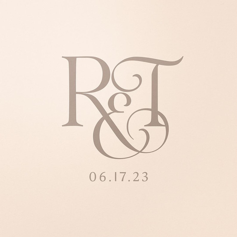 May include: A light beige background with the letters "R & T" in a stylized, elegant font. Below the letters is the date "06.17.23" in a simple, sans-serif font. The overall design is simple and classic.